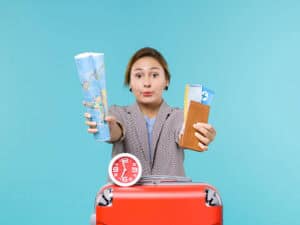 Woman holding travel documents and a map for visa application.