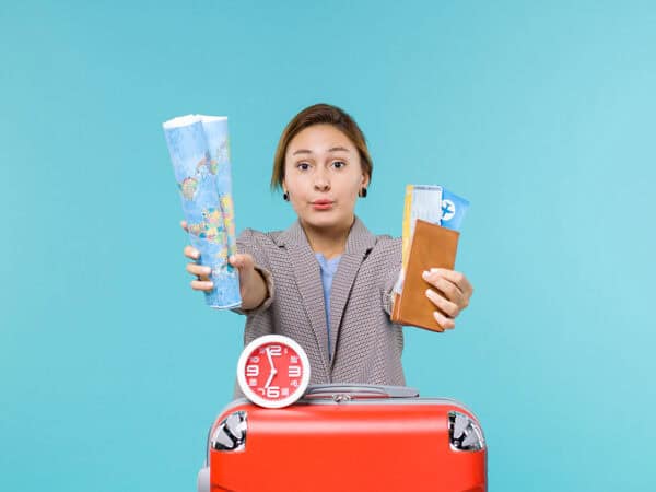 Woman holding travel documents and a map for visa application.